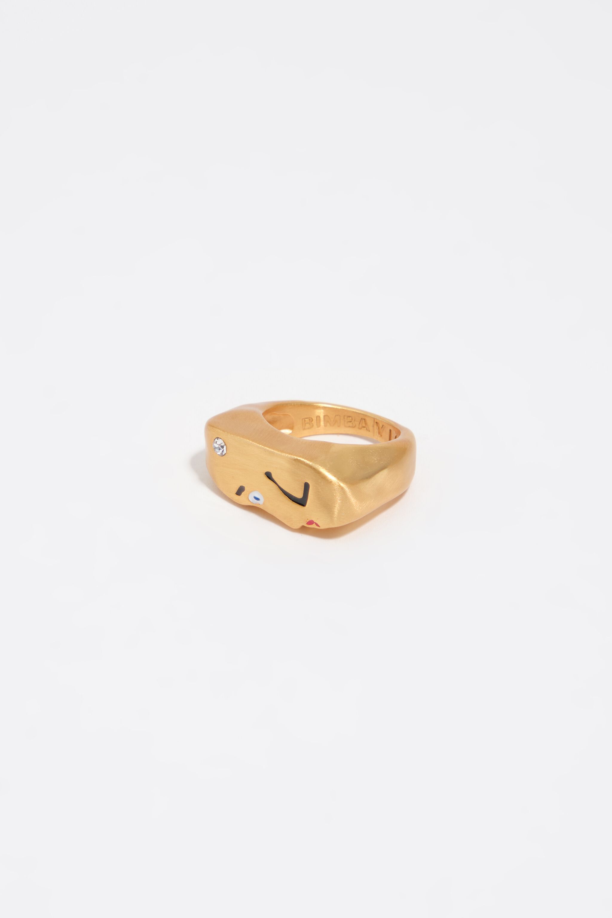 Matt guld ring med ansikte och kristall